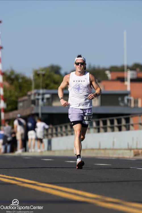 Coach Ryan, UESCA-certified running coach, mid-stride during a run session